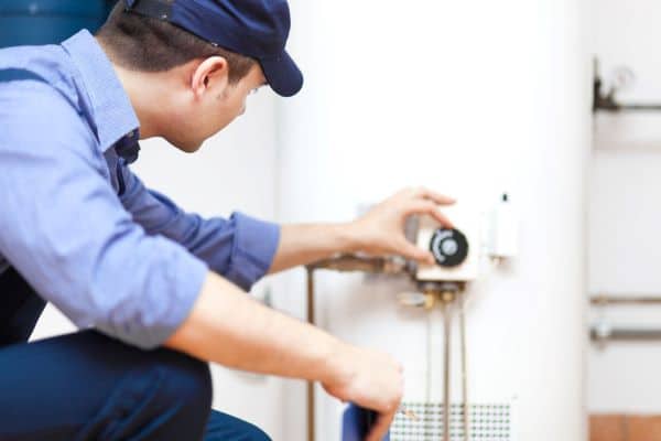 Technician Adjusting Water Heater 1